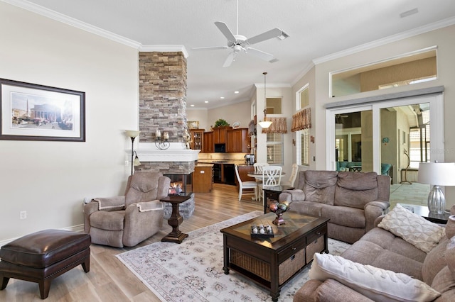 living area featuring ornamental molding, light wood-style floors, and a fireplace