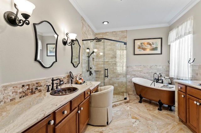 bathroom with crown molding, tile walls, a shower stall, vanity, and a freestanding tub