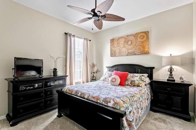 bedroom with a ceiling fan and light carpet