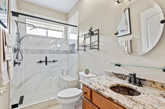 full bathroom featuring a marble finish shower, vanity, and toilet