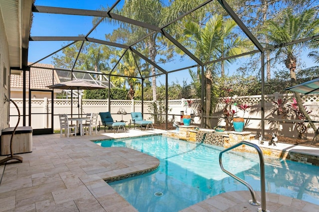 view of swimming pool with a fenced in pool, a patio area, fence, a lanai, and a jacuzzi