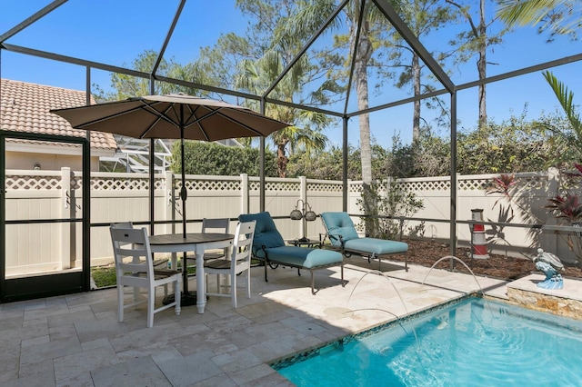 view of patio with a fenced in pool, outdoor dining space, a lanai, and a fenced backyard