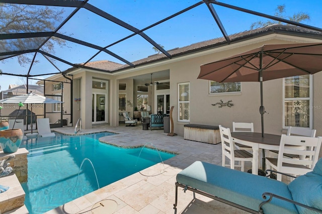 pool with outdoor dining space, a patio area, and a ceiling fan