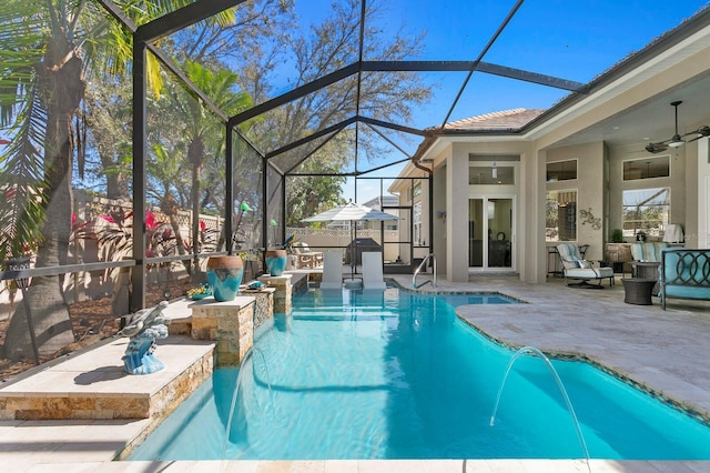 pool with a patio area, a lanai, and a ceiling fan