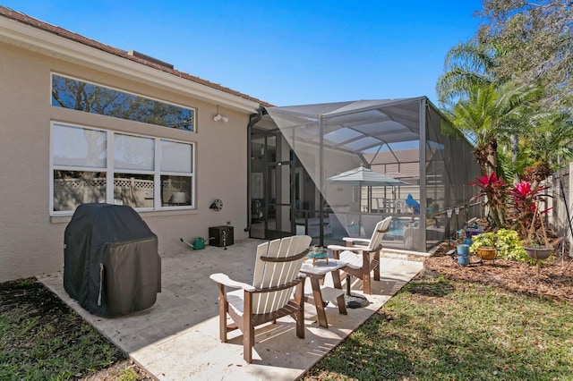 view of patio featuring a lanai and a grill