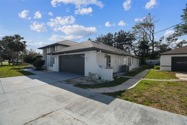 view of side of home featuring a garage, central AC, a shingled roof, driveway, and stucco siding