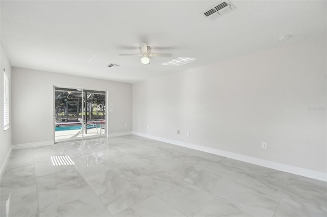 empty room featuring marble finish floor, baseboards, visible vents, and a ceiling fan