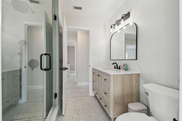 full bathroom with toilet, an enclosed shower, vanity, and visible vents