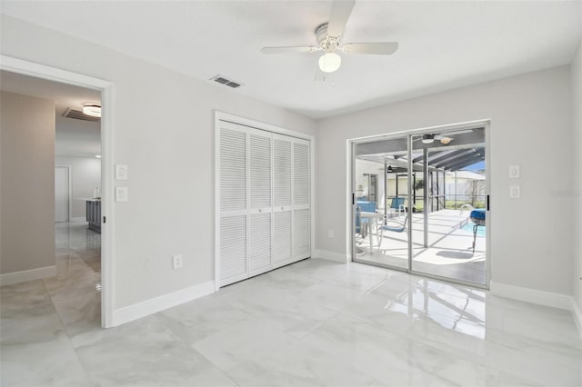 unfurnished bedroom featuring baseboards, visible vents, a sunroom, and access to exterior