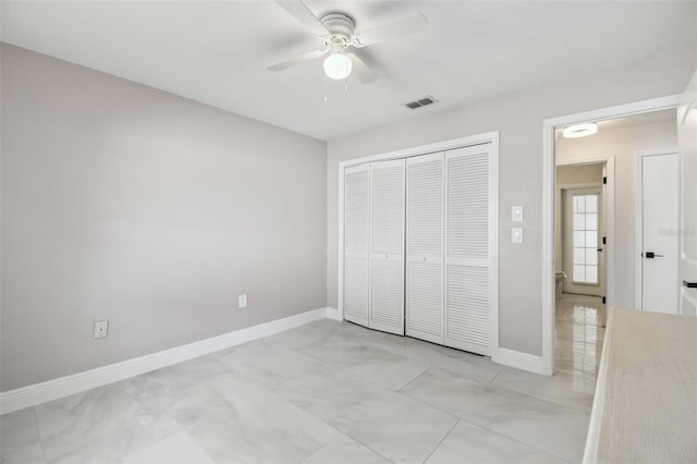 unfurnished bedroom featuring ceiling fan, a closet, visible vents, and baseboards