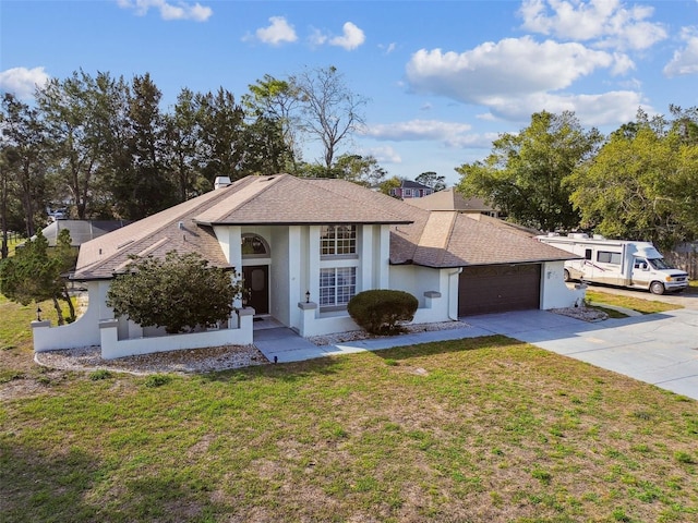 view of front of property featuring a garage, driveway, a front lawn, and stucco siding