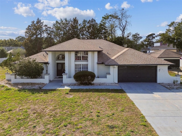 view of front facade featuring an attached garage, a front lawn, concrete driveway, and stucco siding