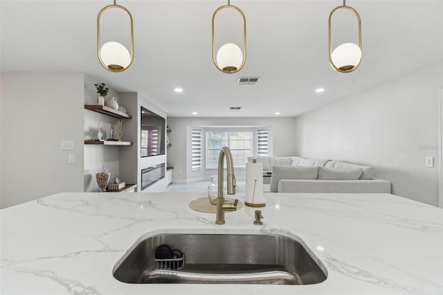 kitchen with visible vents, a sink, and decorative light fixtures