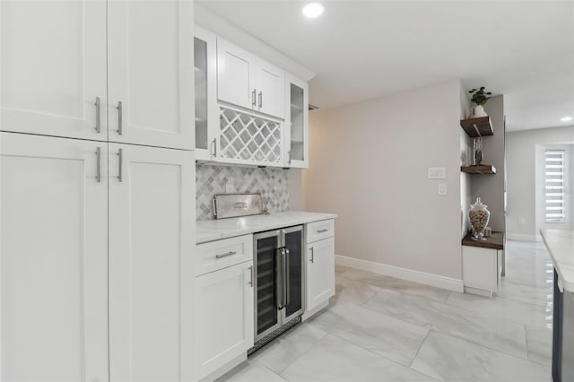 bar featuring a dry bar, baseboards, decorative backsplash, wine cooler, and recessed lighting