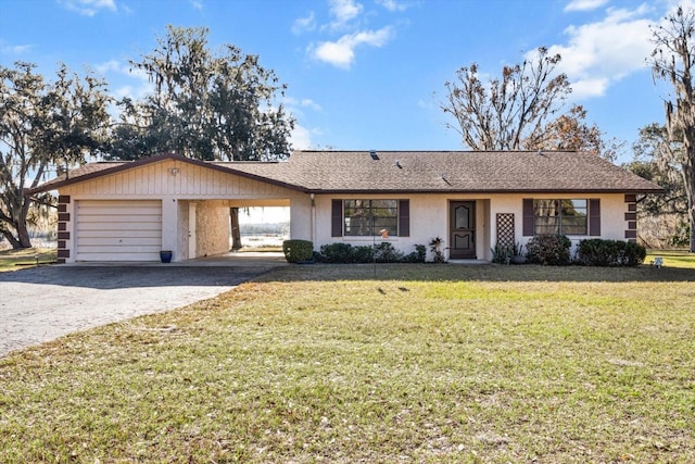 single story home featuring an attached garage, driveway, and a front yard