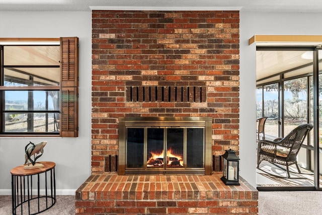 interior details featuring carpet flooring, a fireplace, and a textured ceiling