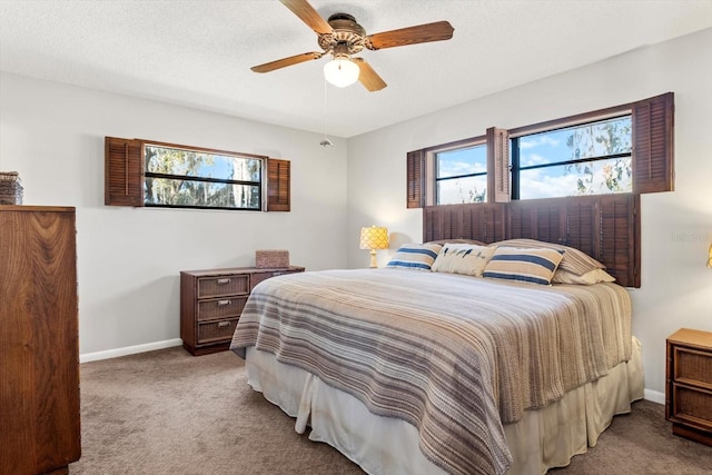 bedroom with light carpet, ceiling fan, a textured ceiling, and baseboards