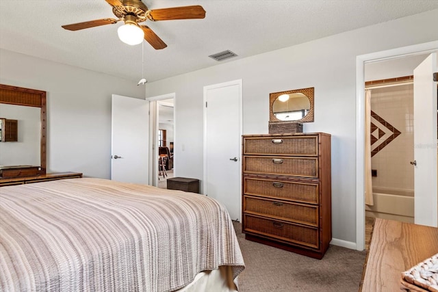 bedroom with a textured ceiling, carpet, visible vents, and a ceiling fan