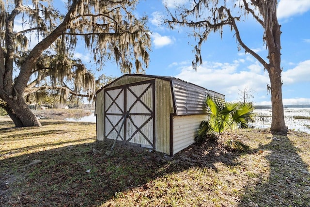 view of shed with a water view