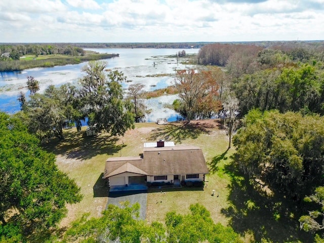 birds eye view of property with a water view and a forest view