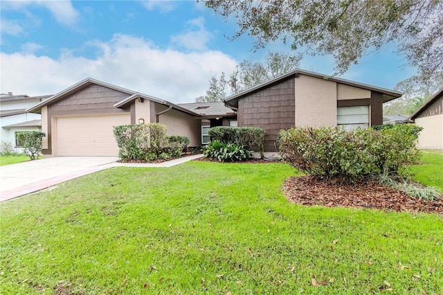 mid-century modern home with concrete driveway, an attached garage, a front lawn, and stucco siding