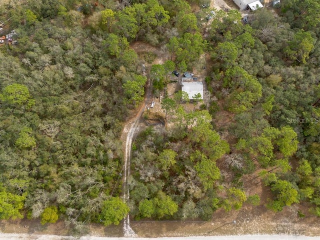 drone / aerial view featuring a view of trees