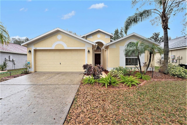 single story home featuring a garage, driveway, and stucco siding