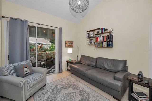 living area with lofted ceiling and light tile patterned floors