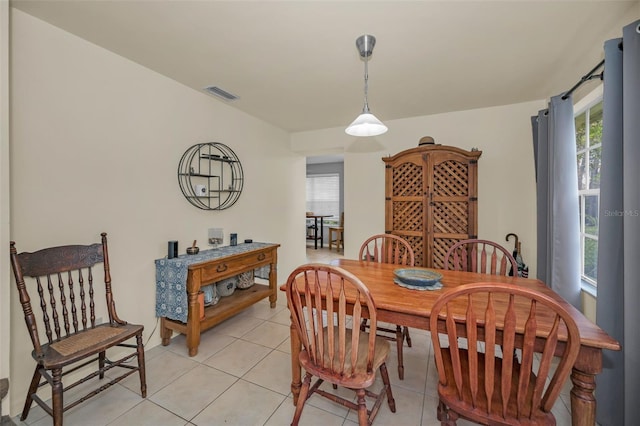 dining space with light tile patterned floors and visible vents