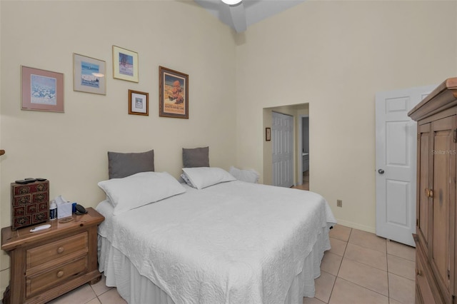 bedroom with light tile patterned floors and baseboards