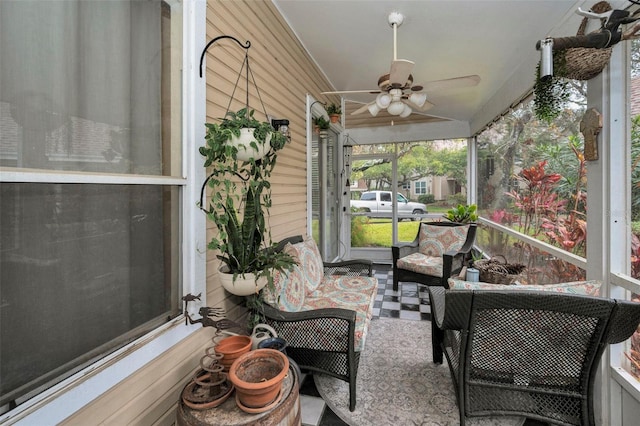 sunroom featuring a ceiling fan