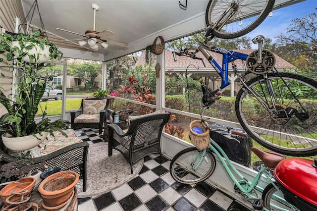 sunroom featuring a ceiling fan