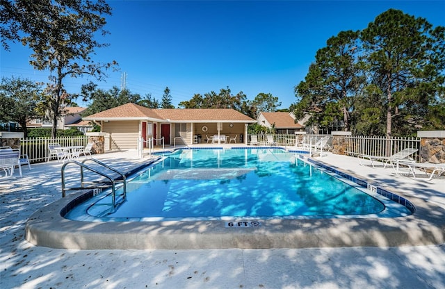 community pool featuring fence and a patio