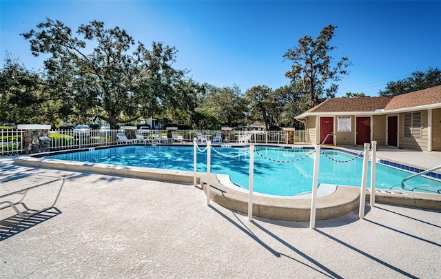 pool with fence and a patio