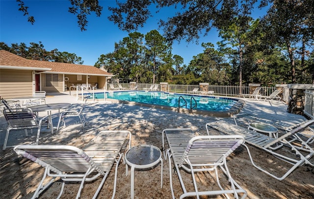 pool featuring a patio and fence