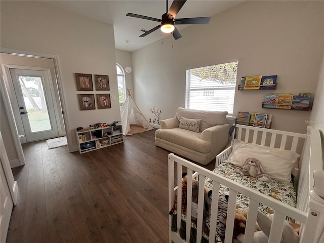 bedroom featuring vaulted ceiling, ceiling fan, multiple windows, and dark wood finished floors