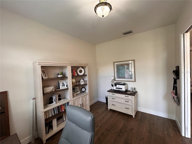 home office with baseboards, visible vents, and dark wood-type flooring