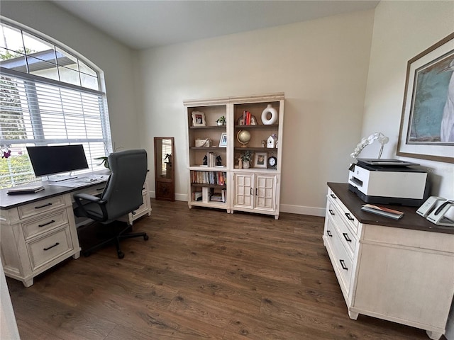 office space with dark wood-type flooring and baseboards