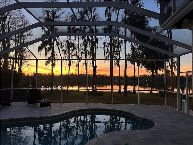 pool with glass enclosure and a patio area