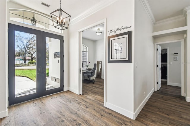 1301 Jen Ma Jo Ln, Lutz, FL 33549 - foyer entrance featuring french doors, crown molding, wood finished floors, a chandelier, and plenty of natural light