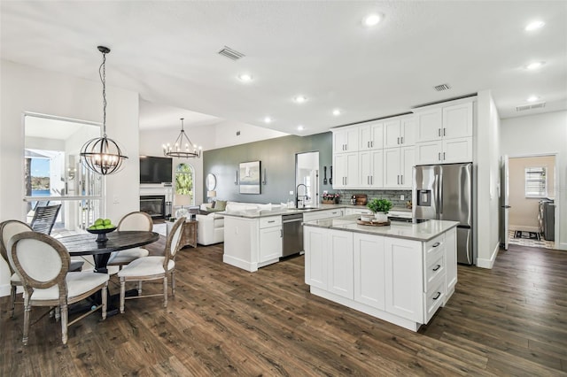 1301 Jen Ma Jo Ln, Lutz, FL 33549 - kitchen with stainless steel appliances, a peninsula, open floor plan, dark wood-style flooring, and recessed lighting