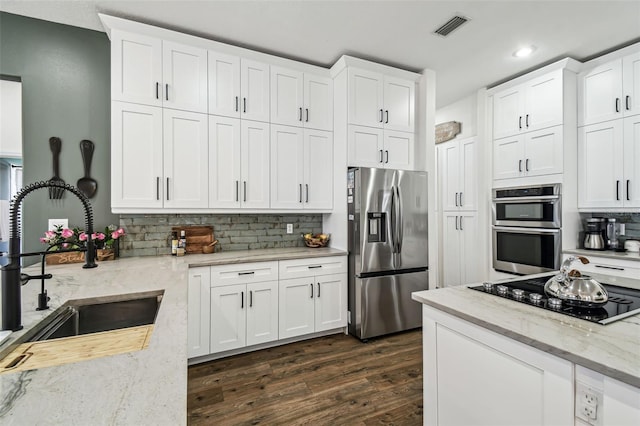 1301 Jen Ma Jo Ln, Lutz, FL 33549 - kitchen featuring stainless steel appliances, backsplash, dark wood-style flooring, white cabinets, and recessed lighting