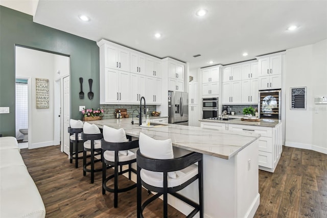 1301 Jen Ma Jo Ln, Lutz, FL 33549 - kitchen featuring appliances with stainless steel finishes, a peninsula, backsplash, dark wood-style flooring, and recessed lighting
