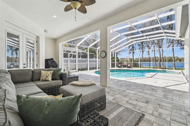 1301 Jen Ma Jo Ln, Lutz, FL 33549 - swimming pool featuring an outdoor hangout area, a patio, ceiling fan, glass enclosure, and a water view