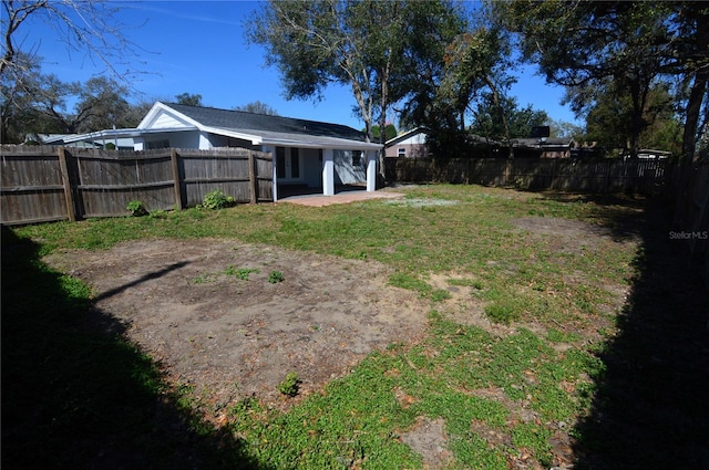 view of yard with a fenced backyard and a patio