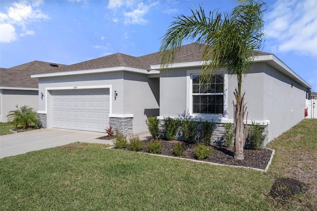 view of front facade with a front yard, concrete driveway, an attached garage, and stucco siding