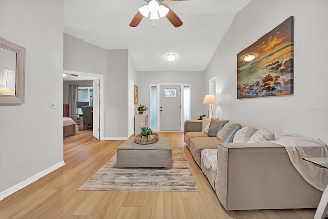 living room with light wood-style floors, baseboards, and a ceiling fan