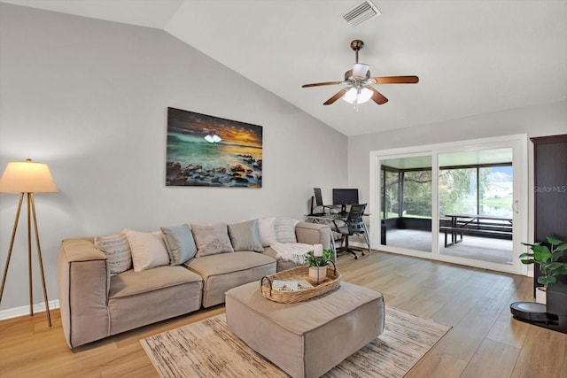 living area featuring visible vents, light wood-style flooring, a ceiling fan, vaulted ceiling, and baseboards