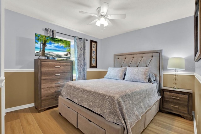 bedroom featuring baseboards, ceiling fan, and light wood finished floors