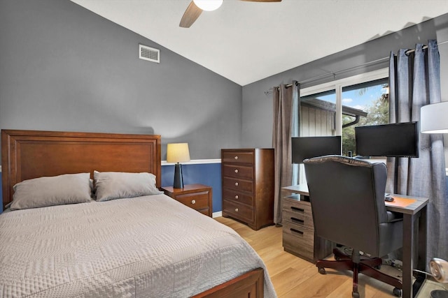 bedroom with light wood-style floors, ceiling fan, visible vents, and vaulted ceiling